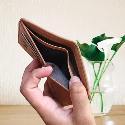 Pak wallets premium tan leather bifold wallet held in hand showing card slots and cash compartments